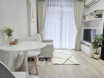 Modern living room with cozy decor, featuring a sleek TV setup and elegant dining area.