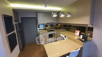 Modern kitchen with sleek cabinetry and integrated appliances in a stylish apartment.