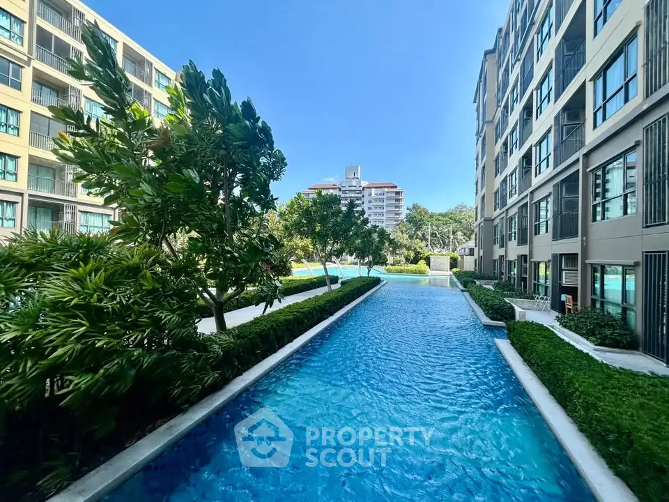 Luxurious residential building with stunning pool and lush greenery