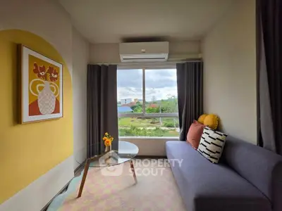Charming living room with modern decor and scenic window view, perfect for relaxation and comfort.