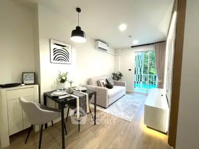 Modern living room with dining area and balcony view, stylish decor and natural light.