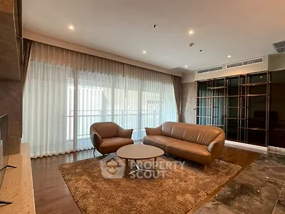 Luxurious living room with elegant leather furniture and large windows