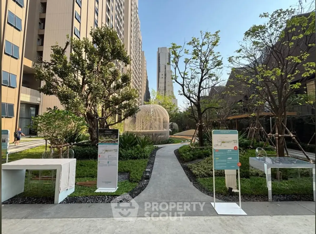 Stunning garden view in modern residential complex with lush greenery and contemporary architecture.