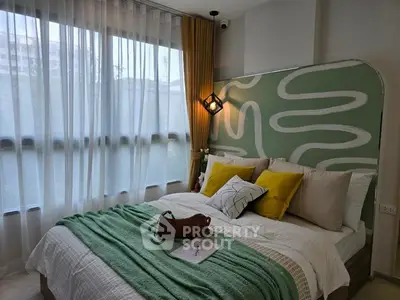 Cozy bedroom with modern decor and large window for natural light