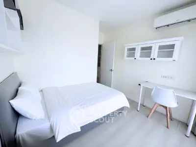 Modern minimalist bedroom with white decor and sleek furniture