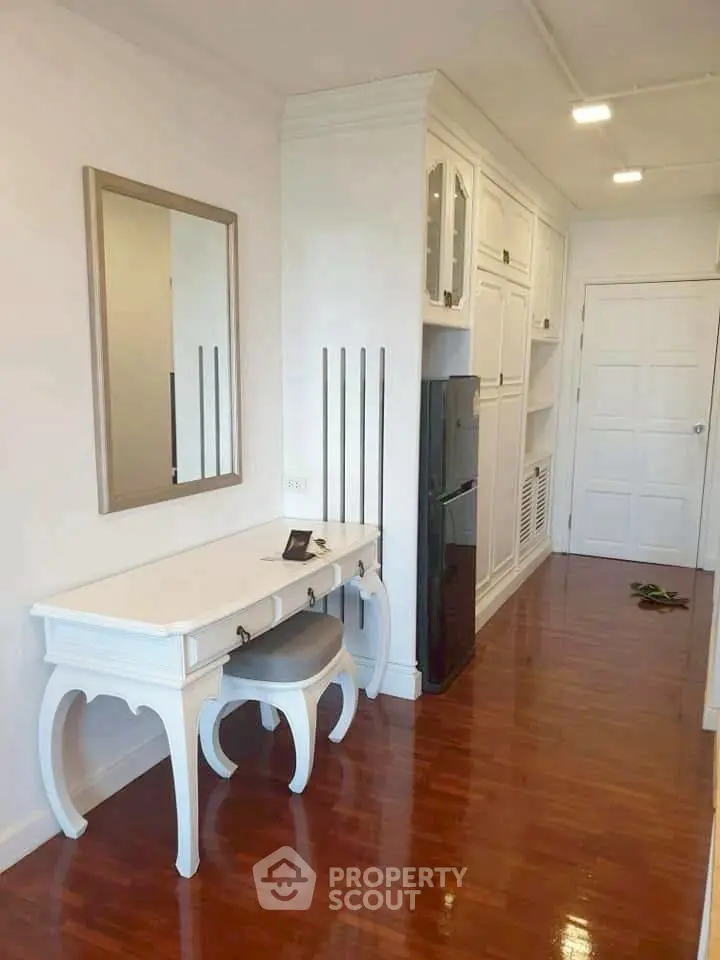 Elegant hallway with white furniture and polished wooden floor