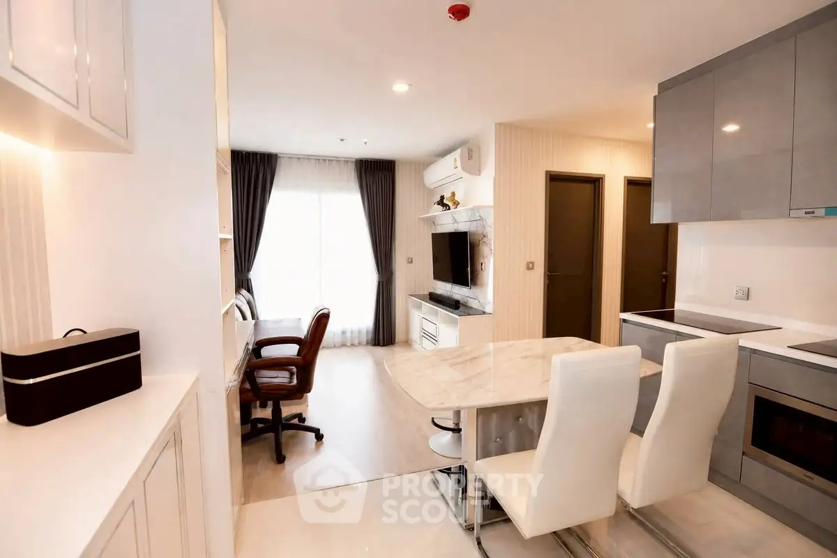 Modern open-plan kitchen and living area with sleek design and natural light.