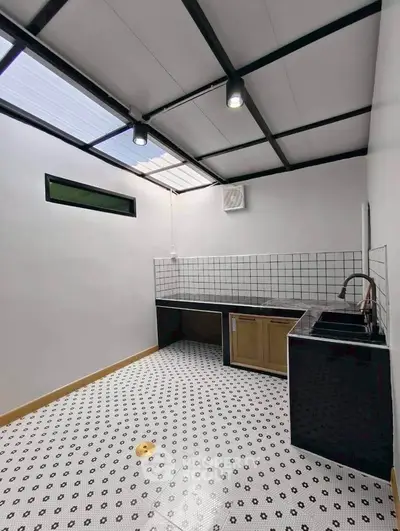 Modern kitchen with sleek black and white tile flooring and open layout.