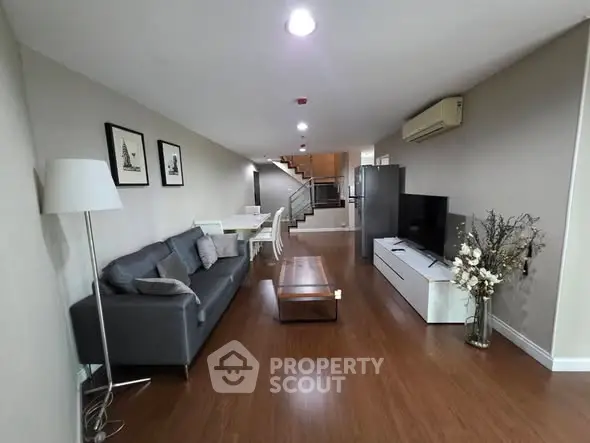 Spacious modern living room with sleek furniture and wooden flooring