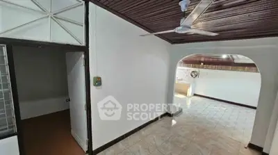 Spacious interior with tiled floors and ceiling fan, ideal for customization.