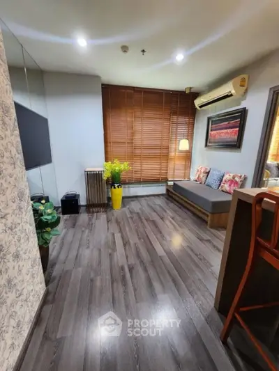 Chic living room with wooden flooring, stylish decor, and cozy seating area.