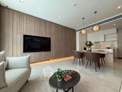 Modern living room with open kitchen, stylish decor, and elegant lighting