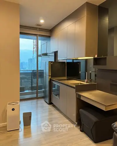 Modern kitchen with sleek cabinetry and city view balcony access.