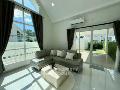Spacious living room with high ceilings and large windows in modern home