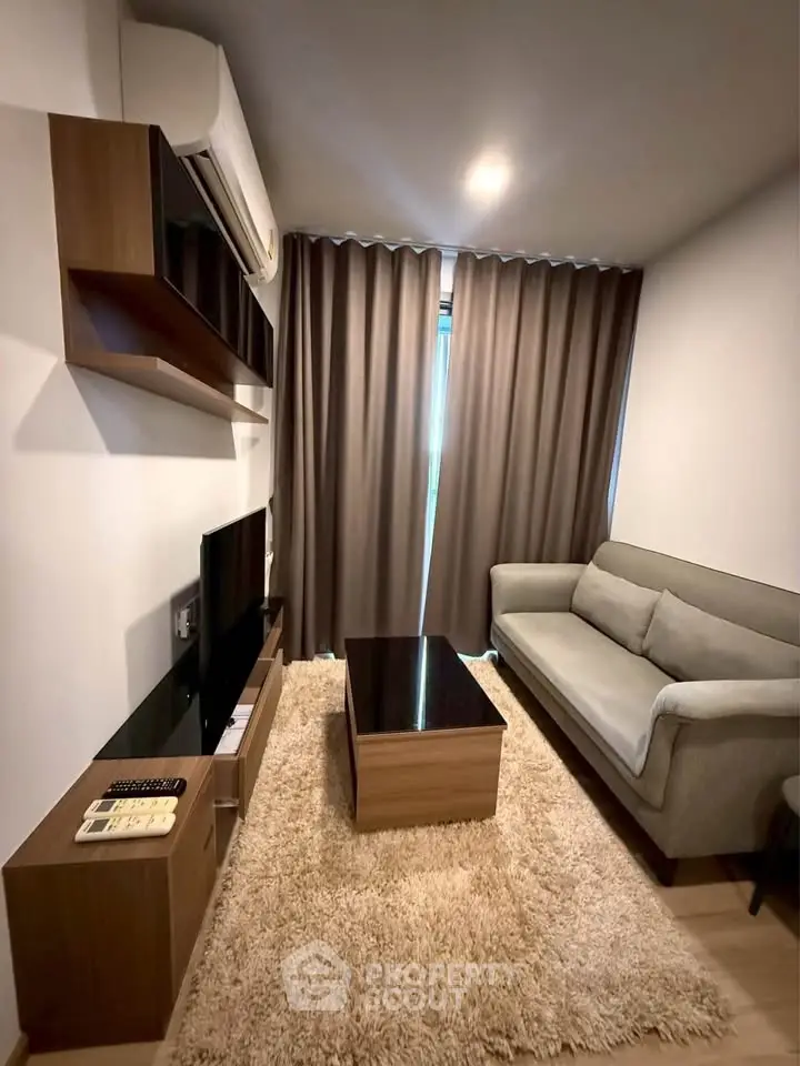 Cozy living room with modern furniture and plush rug, perfect for relaxation.