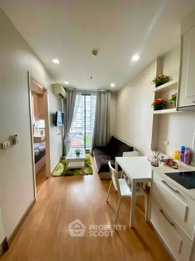 Modern apartment interior with cozy living room and dining area, featuring large window with city view.