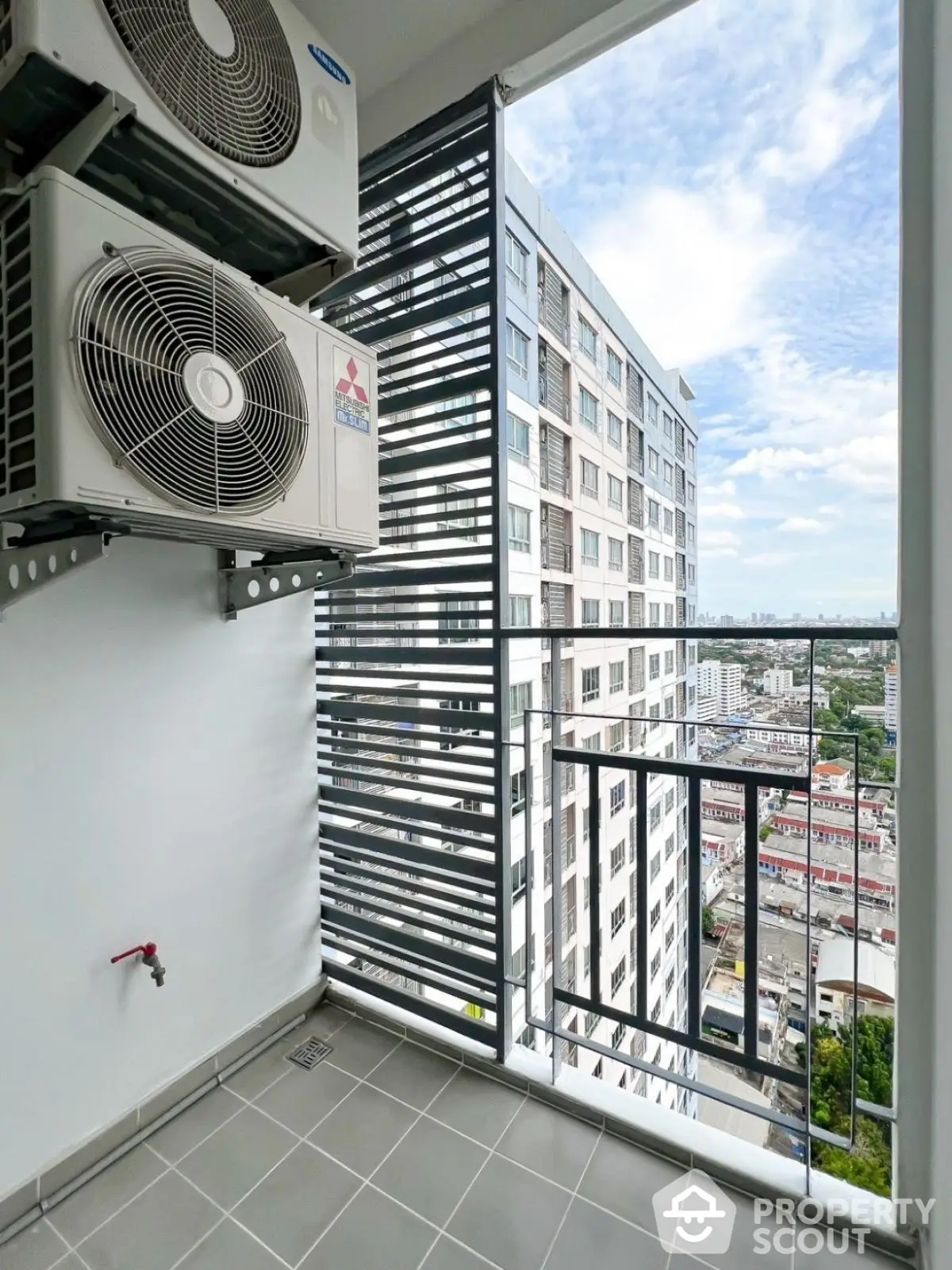 Modern balcony with city view and air conditioning units in high-rise building