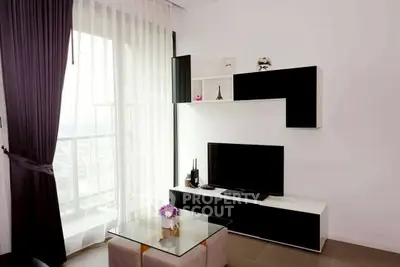 Modern living room with sleek black and white decor, large window, and stylish furniture.