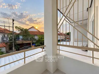 Charming balcony with sunset view in a suburban neighborhood, perfect for relaxation.