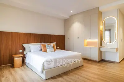 Modern bedroom with stylish wooden accents and built-in wardrobe