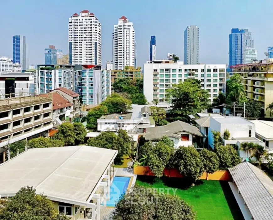 Stunning cityscape view with modern high-rise buildings and lush greenery, perfect for urban living.