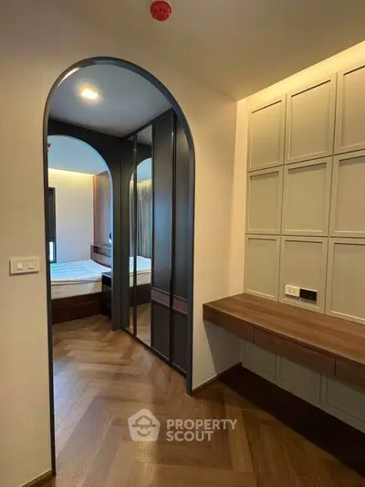 Modern bedroom with elegant wood flooring and stylish built-in wardrobe
