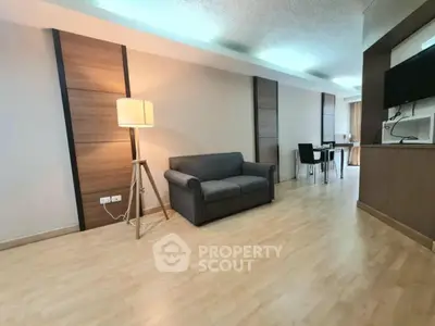 Spacious living room with modern decor and open dining area