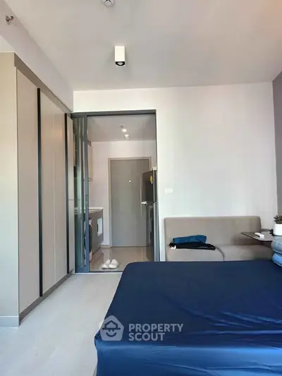 Modern bedroom with sleek design and ensuite bathroom in a stylish apartment.