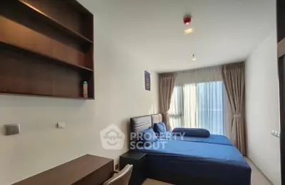 Modern bedroom with twin beds and study desk, featuring natural light and elegant decor.