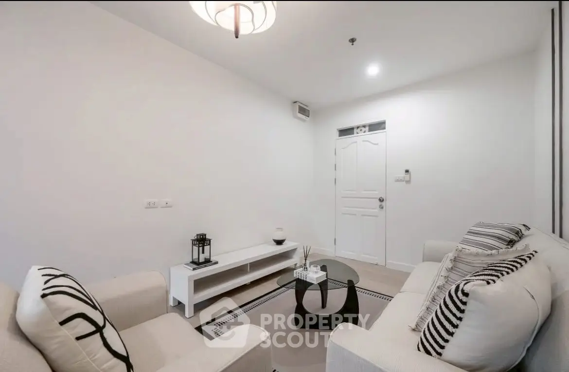 Modern minimalist living room with white decor and cozy seating