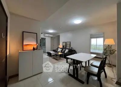 Modern open-plan living and dining area with stylish decor and natural light.