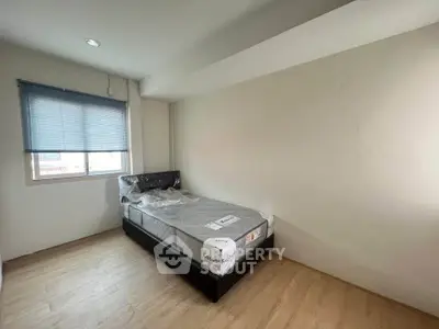 Cozy bedroom with natural light and minimalist design, perfect for relaxation and comfort.