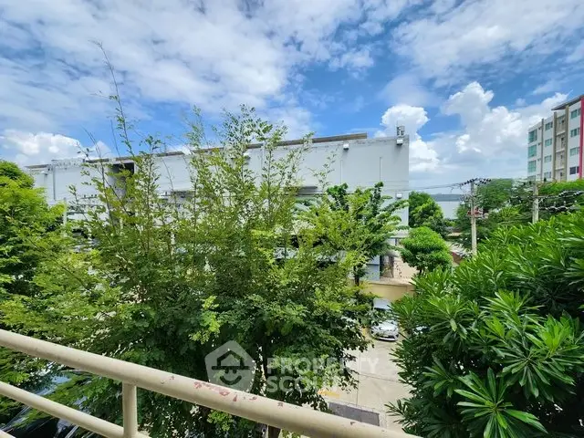 Lush garden view from balcony with clear blue sky