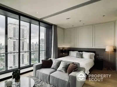 Luxurious bedroom with stunning city view and modern decor in high-rise apartment.