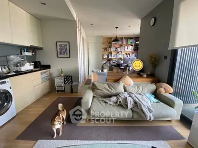 Modern living room with cozy sofa, open kitchen, and stylish decor in a bright apartment.