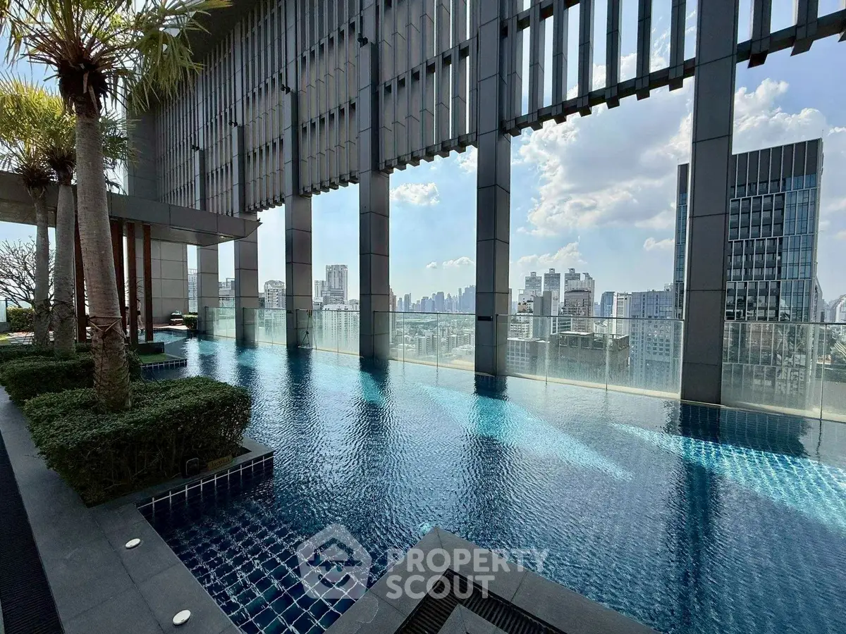 Luxurious rooftop pool with stunning city skyline views in modern high-rise building.