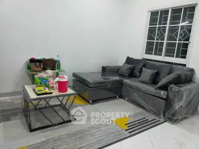 Modern living room with stylish gray sofa and geometric coffee table