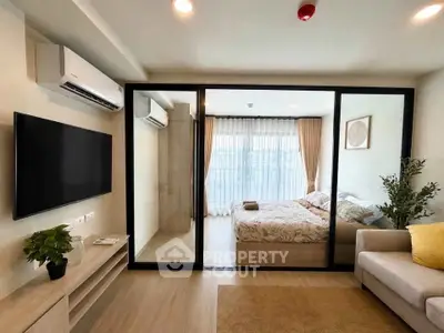 Modern apartment with glass partitioned bedroom and cozy living area