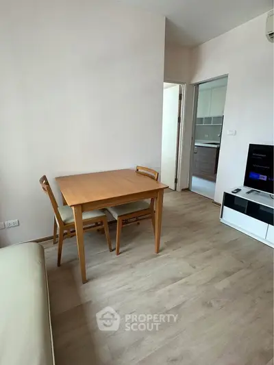 Modern living room with wooden dining table and open kitchen layout