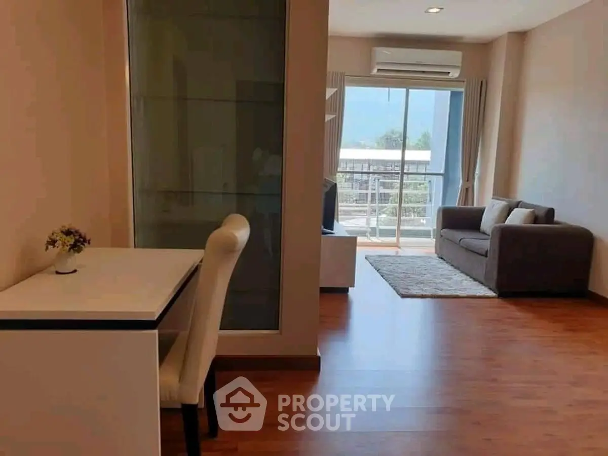 Modern living room with wooden flooring and balcony view