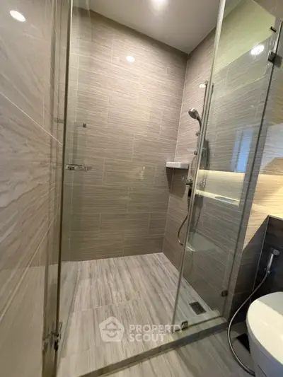 Modern bathroom with glass shower enclosure and sleek tile design