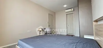 Modern bedroom with minimalist design and study desk, featuring neutral tones and sleek finishes.