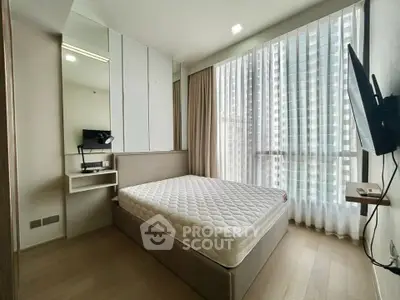 Modern bedroom with large windows and minimalist decor in a high-rise apartment.