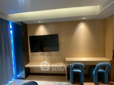 Modern living room with sleek TV setup and stylish seating area