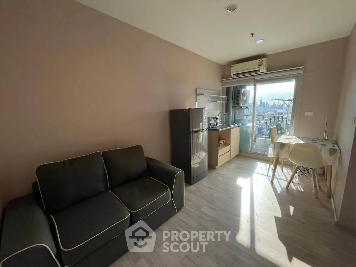 Cozy living room with kitchenette and city view balcony in modern apartment