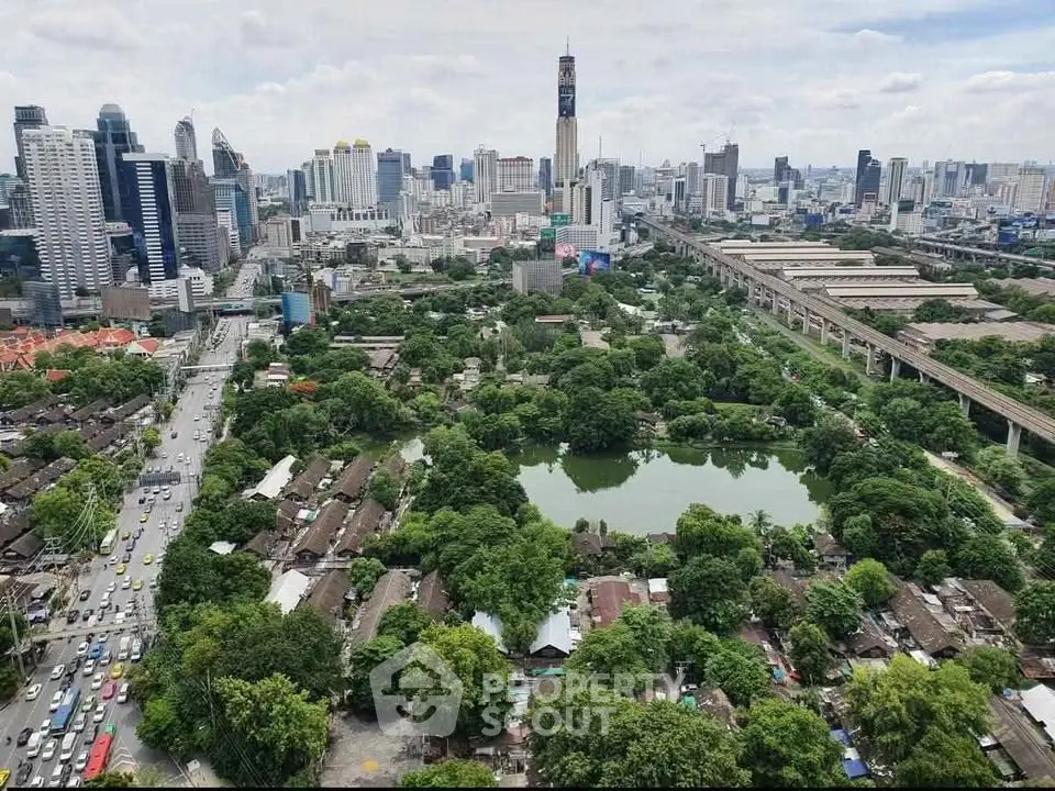 Stunning aerial view of urban skyline with lush greenery and serene water body, perfect for real estate investment.