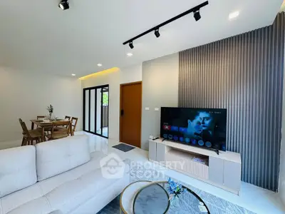 Modern living room with stylish decor and open dining area