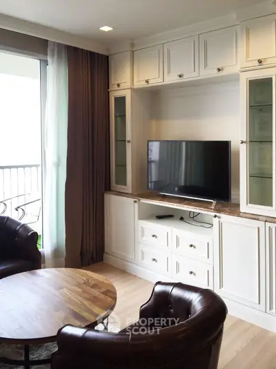 Elegant living room with built-in TV cabinet and leather chairs, perfect for modern comfort and style.