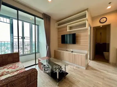 Modern living room with balcony view, stylish furniture, and wall-mounted TV in a high-rise apartment.