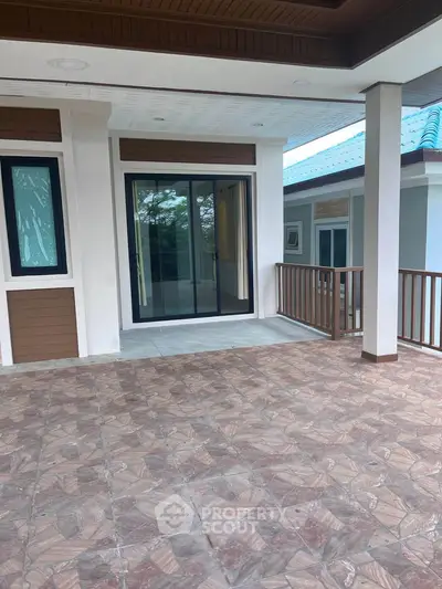 Spacious balcony with elegant tile flooring and sliding glass doors